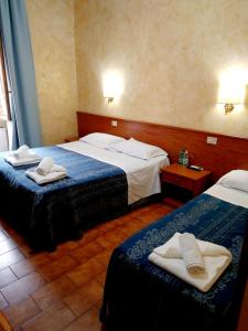 Postel nebo postele na pokoji v ubytování Hotel Ferrari