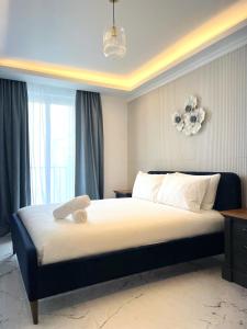 a bedroom with a large bed with a large window at Msida Marina Apartments in Msida