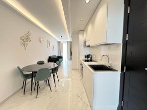 a kitchen and dining room with a table and chairs at Msida Marina Apartments in Msida