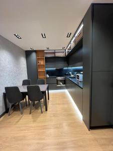 a kitchen and dining room with a table and chairs at Tirana LUX Apartments in Tirana