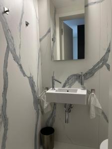 a bathroom with a sink and a mirror at Penati golf by Kate in Šajdíkove Humence