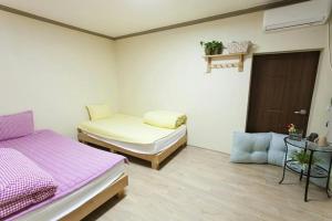 Postel nebo postele na pokoji v ubytování Danaharu Guesthouse