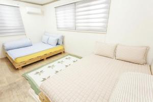 Postel nebo postele na pokoji v ubytování Danaharu Guesthouse