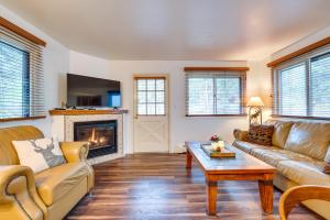a living room with a couch and a fireplace at Estes Park Condo Rental Balcony with River Views! in Estes Park