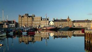 a city with a harbor with boats in the water at Fara 2 room, 1 bedroom - B&B private suite in Kirkwall