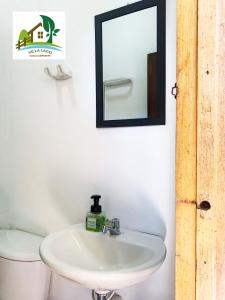 a bathroom with a sink and a mirror on the wall at Casa Campestre Villa Lago in Quebradanegra +39 photos