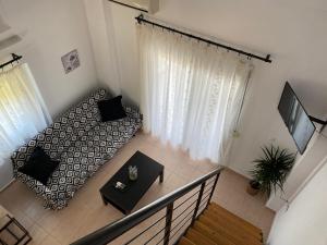 a living room with a bed and a television at Sofia studios in Nea Skioni