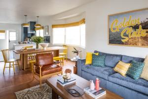 a living room and dining room with a blue couch at The Richland in Orange