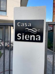 a sign for a santa cruz car dealership at Vila Siena in Sulina