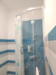 a bathroom with a shower with blue tiles at LA REGGIA APARTMENTS MILAZZO in Milazzo