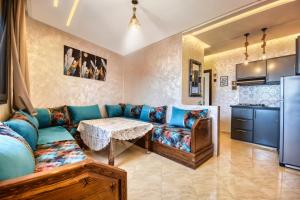 a living room with a couch and a table at imsouane bleu bay house in Imsouane
