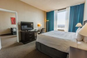 a hotel room with a bed and a flat screen tv at Travelodge by Wyndham Quebec City Hotel & Convention Centre in Quebec City