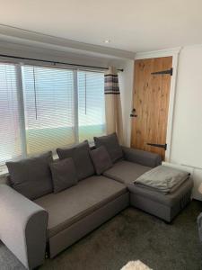 a living room with a couch and a window at Beautiful studio apartment in Pembrokeshire