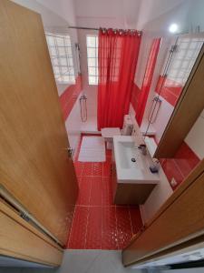 a bathroom with two sinks and a red shower curtain at Vlasis home in Nafpaktos
