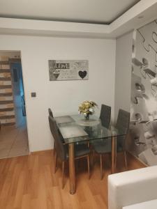 a dining room with a glass table and chairs at Vip apart in Gorlice