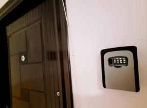 a door with a remote control attached to a wall at Christal Apartment in Bacău