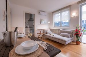 a living room with a table and a couch at Residence Santa Tecla in Trieste