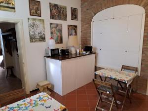 une cuisine avec un comptoir et une table avec des chaises dans l'établissement B&B All'Aeroporto, à Curtatone