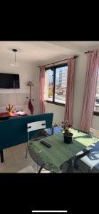 a living room with a table and a kitchen at APART HOTEL OFFICE céntrico in San Salvador de Jujuy