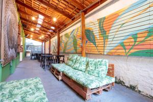 a room with a couch and a table with chairs at Local Hostel Manaus in Manaus