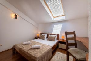 a bedroom with two beds and a window at Apartments Vranjić in Trogir
