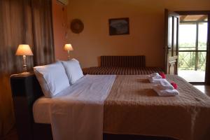 a bedroom with a bed with two stuffed animals on it at PIGADIA in Vromonérion