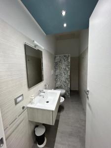 y baño con lavabo y espejo. en Santorini 2.0, en San Pietro in Bevagna