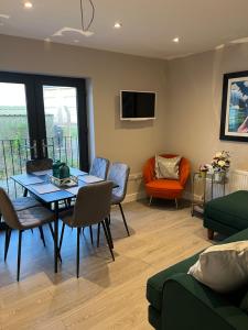 a living room with a table and chairs at seaview 87 in Portrush