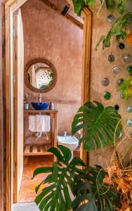 a bathroom with a sink and a mirror at Caliu Earthship Ecolodge in Colonia del Sacramento