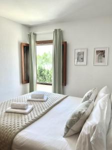 a bedroom with a large bed with two pillows on it at Elena Playa Sol in Alcudia