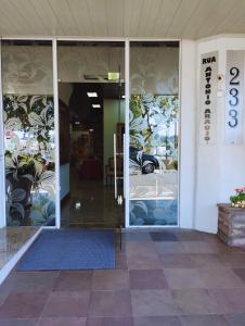 an entrance to a store with glass doors at Germanias Blumen Hotel in Passo Fundo