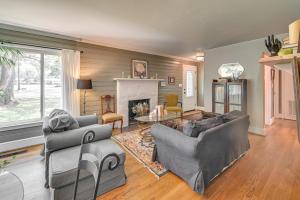 a living room with two couches and a fireplace at Cute Downtown Conway Duplex - 15 Mi to Beach! in Conway