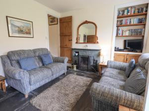 a living room with two couches and a fireplace at Slaters Rest in Chapel Stile