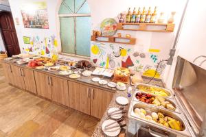 a kitchen with a bunch of food on a counter at Local Hostel & Suites Manaus in Manaus