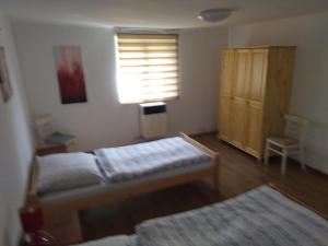 A bed or beds in a room at Ubytovanie Tibor Skarba