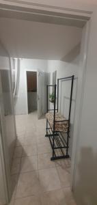 a room with a chair sitting on a tiled floor at Chris -Nikol STUDIO in Kallithea Halkidikis