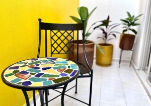 a table and a chair with plants in a room at Real Cocula in Cocula
