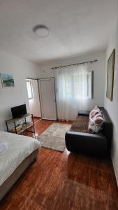ein Wohnzimmer mit einem Bett und einem Schreibtisch in der Unterkunft Gazdinstvo Kraljevic in Kraljevići