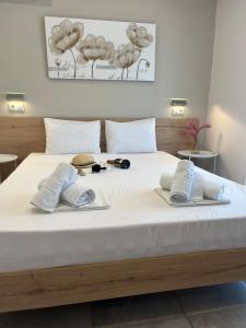a bedroom with a bed with two towels on it at House Kohili in Nea Vrasna