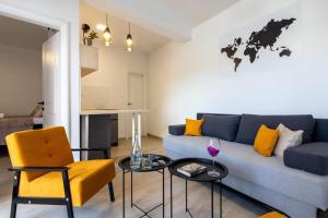 a living room with a blue couch and a table at Ankica & Anamarija Apartments in Neum