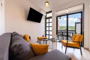 a living room with a couch and a table at Ankica & Anamarija Apartments in Neum