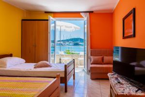a bedroom with two beds and a view of the water at Apartments Mikulić in Rogoznica