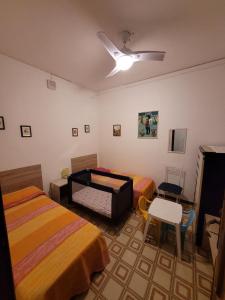 - une chambre avec deux lits, une table et une chaise dans l'établissement A casa di Nonna Giò, à Palerme