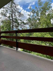 a wooden fence with trees in the background at Appartement Haute-Nendaz in Nendaz