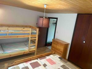 a bedroom with two bunk beds and a door at Appartement Haute-Nendaz in Nendaz