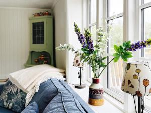 a bedroom with vases of flowers on a window sill at Holiday home ALLINGSÅS, SVERIGE II in Hjälmared