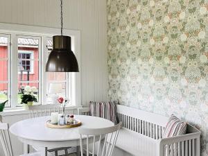 a dining room with a white table and chairs at Holiday home ALLINGSÅS, SVERIGE II in Hjälmared