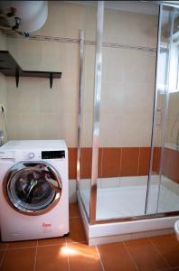 a washing machine in a bathroom with a shower at Diana’s Place in Alexandroupoli