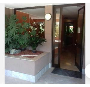 a hallway with two potted plants next to a door at Suite Viola@ in Legnano