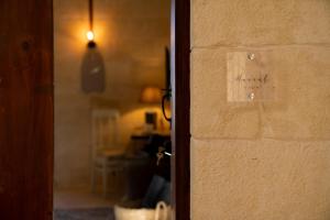 a door with a sign on the side of a wall at Home Mood B&B in Għarb